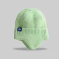 Detailed view of a cozy mint green knit winter beanie featuring ear flaps and a snowflake tag - Elastic Circumference (56-59cm) / Light Green