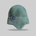 Close-up of green knitted earflap beanie with fuzzy wool texture and snowflake tag - Elastic Circumference (56-59cm) / Dark Green