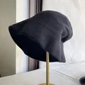Side view of a black pure wool slouchy bucket hat on a display stand - M (56-58cm) Adjustable / Black