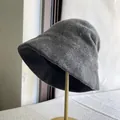 Close-up detail of a dark grey Australian wool bucket hat on a gold display stand - M (56-58cm) Adjustable / Gray