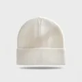 Detailed macro view of a white cuffed knit beanie with ribbed texture for winter warmth. - Elastic Circumference (56-60cm) / White
