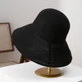 Detailed macro view of a premium black foldable straw sun hat with a large brim - M (56-58cm) / Black
