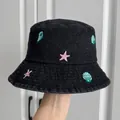 Detail view of children's black denim bucket hat with colorful sea shell embroidery - Black Conch