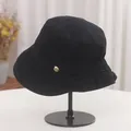 Close-up view of a black pleated vintage style bucket hat on a professional display stand - Adjustable (56-58cm) / Black