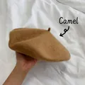 Detailed view of a classic camel wool beret held by hand against a white background. - M (56-58cm) / Camel