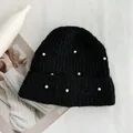 Detailed macro shot of a black knitted beanie hat with elegant white pearl bead decorations - Hat Circumference (53-60cm) Elastic / Black
