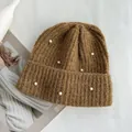Detailed macro view of the thick knit texture and pearl accents on the brown beanie hat. - Hat Circumference (53-60cm) Elastic / Caramel color