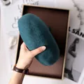Close-up of a hand holding a soft teal wool beret for autumn and winter fashion style - 80S Australian Wool / Adjustable / Peacock Blue
