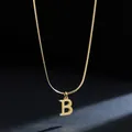 Macro shot of a gold 18K plated stainless steel initial B pendant necklace on dark background - Letter B (11851_2) / Gold