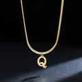 Macro detail of a gold 18K plated stainless steel necklace with initial Q pendant - Letter Q (11851_17) / Gold