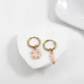 Close-up detail of asymmetric gold stainless steel hoop earrings with peach crystal beads - Pink Peach Faceted Bead Style (21855_4)