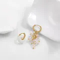 Detailed view of the asymmetrical hoop earrings with white translucent stone clusters. - White Translucent Bead Pendant Style (21855_8)