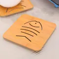 Natural bamboo heat insulation coaster featuring a decorative hollow fish cutout design - Small Fish