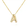Macro detail view of a polished gold bubble letter A necklace with a satellite chain - Gold Letter A