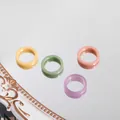 Close-up of four colorful pastel acrylic rings on a reflective mirror surface - Four-Piece Set / Candy Color 4 Piece Set (R176_12)