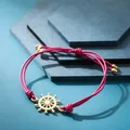 Braccialetto artigianale in corda intrecciata rosa con ciondolo timone dorato da donna - Timone Rosa