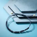 Bracciale in cordino intrecciato a mano blu navy con accenti dorati - Stile Intrecciato Blu