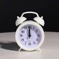 Classic white twin-bell silent alarm clock with clear black Arabic numerals for bedroom - White