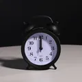 Classic matte black silent bedside alarm clock with a minimalist white dial face - Black