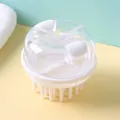 White silicone scalp massage brush with dual-compartment liquid dispenser and clear lid. - White
