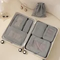 Set of 7 grey travel packing cubes and laundry bags neatly organized inside a beige suitcase - Dark Gray
