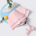 Elegant pink tri-fold umbrella featuring musical note pattern and a bow-knot handle design - Musical Notes Light Pink (Small Curve Hook)