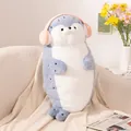 Cute blue and white seal plush toy with pink headphones resting on a soft sofa - Headphone Seal / Blue / 70cm