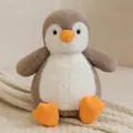 Adorable soft grey and white penguin plush toy sitting on a cozy beige knitted blanket - Penguin