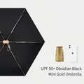 UPF50+ Obsidian Black compact sun umbrella with iPhone for scale comparison - Black (Mini Gold Series)