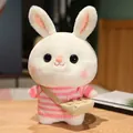 Adorable white plush bunny toy wearing a pink striped sweater and messenger bag - Pink And White Striped Sweater With Bag