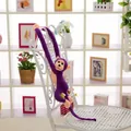 Detail of a purple long-armed monkey plush toy hanging on a white decorative chair. - Single Monkey (Silent) / 60CM / Purple