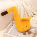 Adorable saxophone plush instrument toy with a smiley face in a cozy basket - Bright yellow