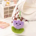 Purple plush tulip flower keychain with a cute smiley face attached to a white bag - Purple Flower Pendant