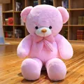 Weicher rosa Riesen-Teddybär als Plüschtier mit einer niedlichen Schleife im Zimmer - Rosa / 80cm