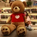 Giant life-size brown plush teddy bear wearing a red heart sweater in a cozy room - Red Sweater Style / 80cm / Dark Brown