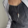 Close-up of a silver lariat necklace featuring teardrop charms and a natural stone bead - Tiger Eye Hoop Style (XL2227) / Tassel Grape Cluster Adjustable Bead Chain