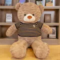 Large brown teddy bear plush toy in a black and yellow striped sweater sitting on wood floor - 0.8m / Dark Brown Brown Stripe