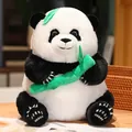 Adorable plush panda toy holding green bamboo sitting on a cozy warm wooden table - 22cm / Bamboo Style