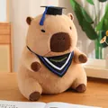 Peluche de capibara adorable con birrete de graduación negro y borla de color azul - Estilo Gorro de Graduación Azul