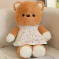 Soft and cute brown plush bear toy wearing a delicate white floral lace dress for gift - Bear