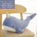 Soft blue narwhal plush toy variant with golden horn shown on a minimalist chair - 60CM / Blue Whale
