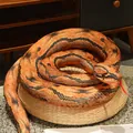 Realistic orange python plush toy curled on a woven stool for prank or decor - Red-banded Python / 110 cm