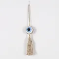 Handmade bohemian crochet evil eye car charm with decorative long tassel on white wall - Camel Border Style (MS9337D)