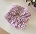 Close-up view showing the pink plaid pattern and delicate lace trim on this fabric scrunchie - Purple Stripe Lace Scrunchie / Pink Purple