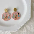Quirky pink acrylic round earrings with leopard and girl illustration on a white plate - Pink Woman And Leopard