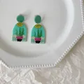 Handmade acrylic drop earrings featuring quirky potted plant design on white plate - Green Cactus