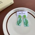 Quirky cute acrylic drop earrings featuring a green cactus design with turquoise stripes - Alternative Green Cactus