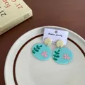 Cute light blue acrylic round earrings featuring pink flowers and green leaf patterns - Blue Oval Drop Pink Floral