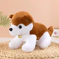 Detailed view of plush Shiba Inu toy with a gold bell on a straw mat - Tan / 30cm