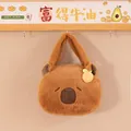 Detailed close-up of a cute brown plush capybara-shaped handbag hanging on a hook - 20cm / Yellow Orange Style